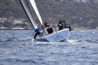 Bodrum, Hindi. 10 Nisan 2022: Yelkenliler Ege Denizi 'nin mavi sularında, ünlü tatil beldesi Bodrum' un kıyılarında rüzgarlı havada yelken açıyorlar..
