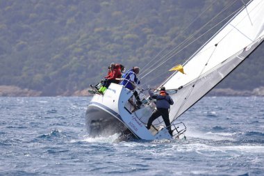 Bodrum, Hindi. 10 Nisan 2022: Yelkenliler Ege Denizi 'nin mavi sularında, ünlü tatil beldesi Bodrum' un kıyılarında rüzgarlı havada yelken açıyorlar..
