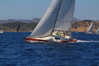 Bodrum,Turkey. 25 May 2019: Sailboats sail in windy weather in the blue waters of the Aegean Sea, on the shores of the famous holiday destination Bodrum.