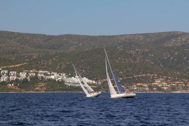 Bodrum,Turkey. 25 May 2019: Sailboats sail in windy weather in the blue waters of the Aegean Sea, on the shores of the famous holiday destination Bodrum.