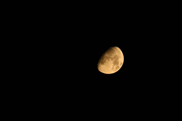 new moon or crescent moon up close in a dark blue night sky