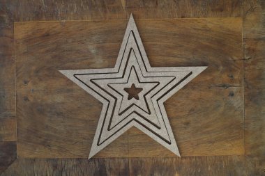 golden star isolated on wooden background