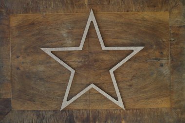 golden star isolated on wooden background