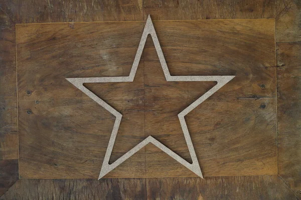 golden star isolated on wooden background