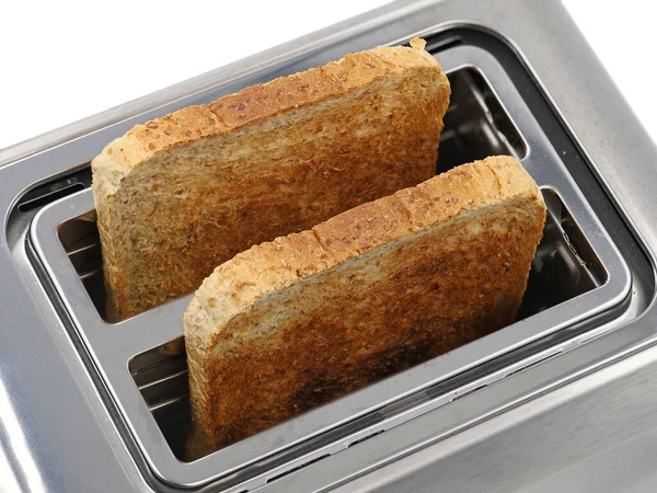 Vista superior da torradeira de aço inoxidável com duas fatias torradas pão multi-grão — Fotografia de Stock