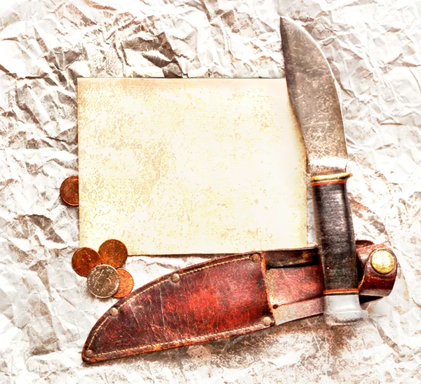 Knife with paper and coins. Grunge background — Stock Photo, Image