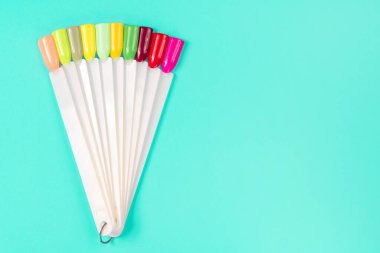 Beyaz arka planda çok renkli tırnak uçları. Tırnaklar için manikür örneği. Çivi renk örnekleriyle palet. 