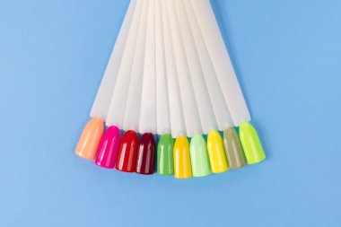 Beyaz arka planda çok renkli tırnak uçları. Tırnaklar için manikür örneği. Çivi renk örnekleriyle palet. 