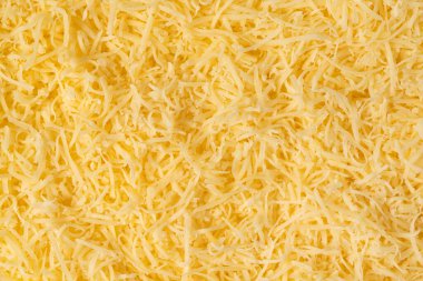 Rendelenmiş peynir arkaplan dokusu. Sarı dilimlenmiş peynir. Üst görünümü kapat.