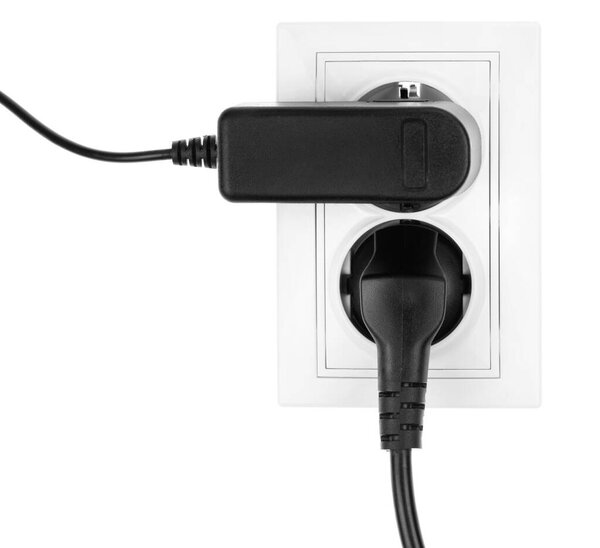 Double power European electric plug isolated on a white. Black electric cord plugged into a white electricity socket on white background