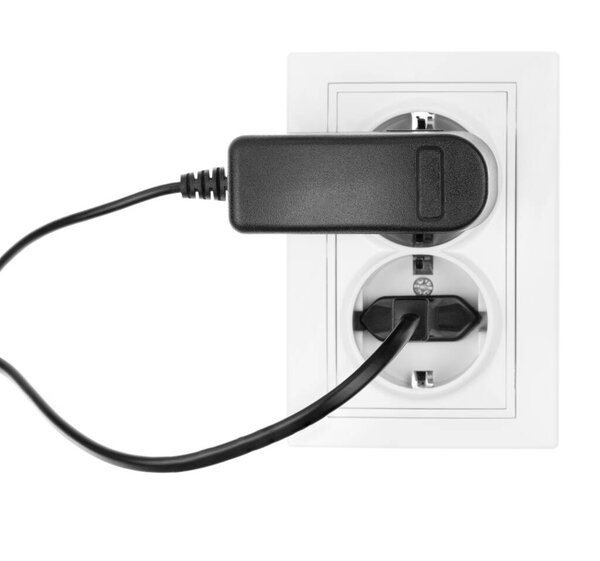 Double power European electric plug isolated on a white. Black electric cord plugged into a white electricity socket on white background