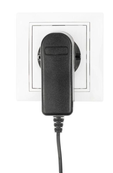 Power European electric plug isolated on a white. black electric cord plugged into a white electricity socket on white background