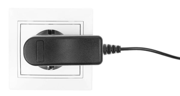 Power European electric plug isolated on a white. black electric cord plugged into a white electricity socket on white background