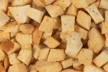 Kurutulmuş krakerlerin arka plan dokusu. Kurutulmuş küçük ekmek parçaları. Ekmek kırıntıları.