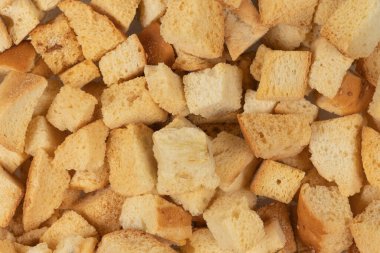 Kurutulmuş krakerlerin arka plan dokusu. Kurutulmuş küçük ekmek parçaları. Ekmek kırıntıları.