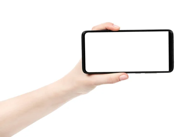 空白の画面で黒の新しいスマートフォンを保持女性の手は白い背景を隔離しました 携帯電話のクリッピングパスを使って デザイナーにとって — ストック写真
