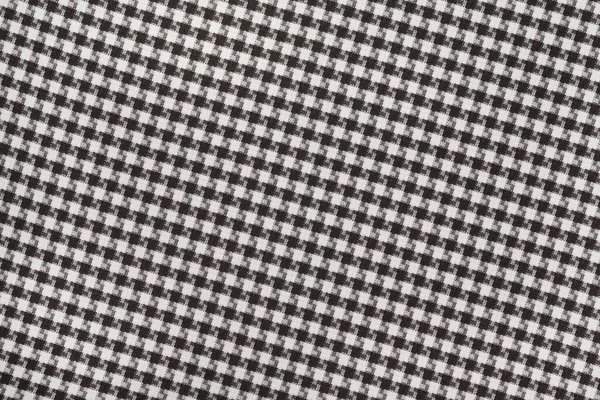 White black textile cloth texture background. shirt fabric with a checkered pattern. factory material