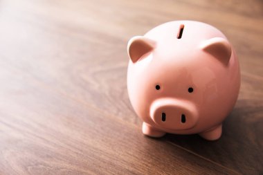 pink piggy bank on the wooden tabl