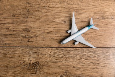 Toy of passenger plane on wooden backgroun