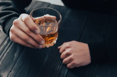 Closeup businessmen holding a glass of whiske