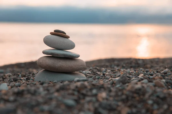 Zen stones on the sea beach at sunse