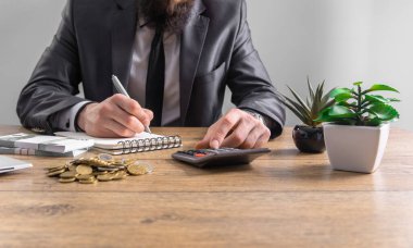 Businessman using calculator and working on financial dat