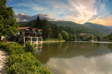 Summer wooden Lake house inside forest