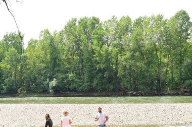 people near the river and amazing nature around