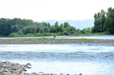 people near the river and amazing nature around