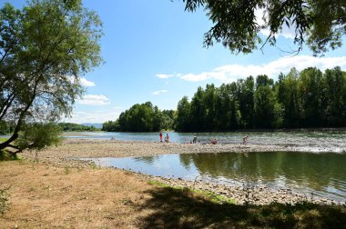 people near the river and amazing nature around