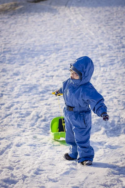 Boy with sledge on snow — Stock Photo, Image