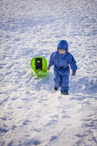 Boy pulling a sledge — Stock Photo, Image