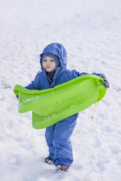 Boy carrying his sledge — Stock Photo, Image