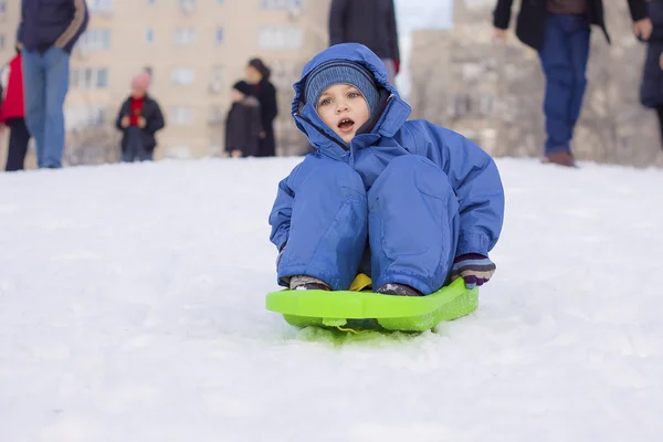 Young boy on sledge — Stock Photo, Image