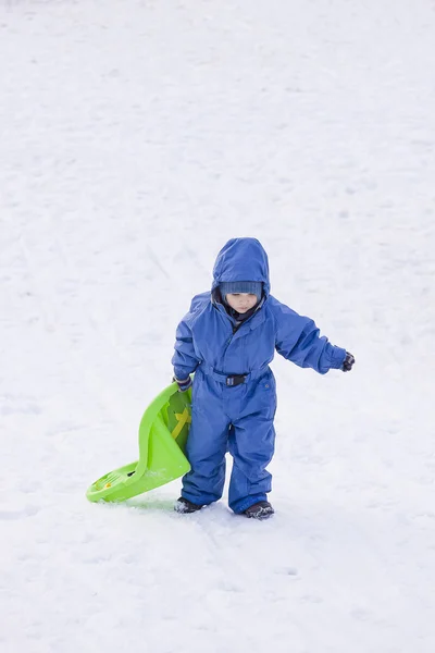 Boy carrying his sledge — Stock Photo, Image