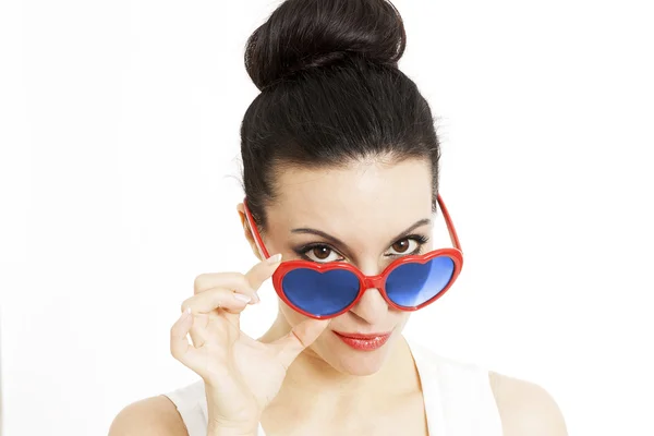 Portrait of a beautiful woman in blue with heart shaped glasses — Stock Photo, Image