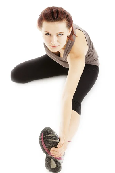 Fitness woman stretching her leg to warm up — Stock Photo, Image