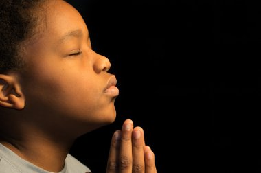 A boy prays to God