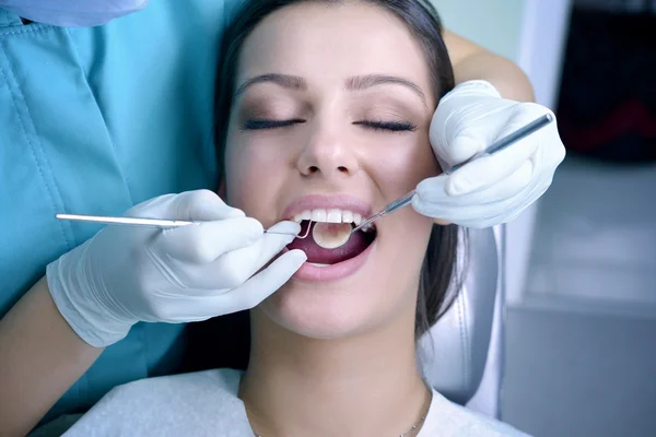 Schöne junge Frau besucht Zahnarzt für zahnärztliche Untersuchung — Stockfoto