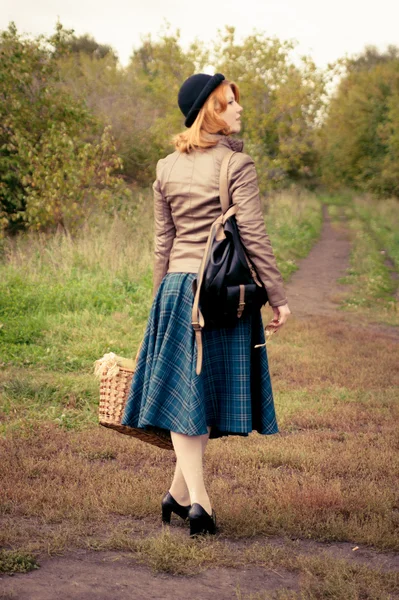 Portrait of a beautiful redhair girl in the autumn park. Royalty Free Stock Photos