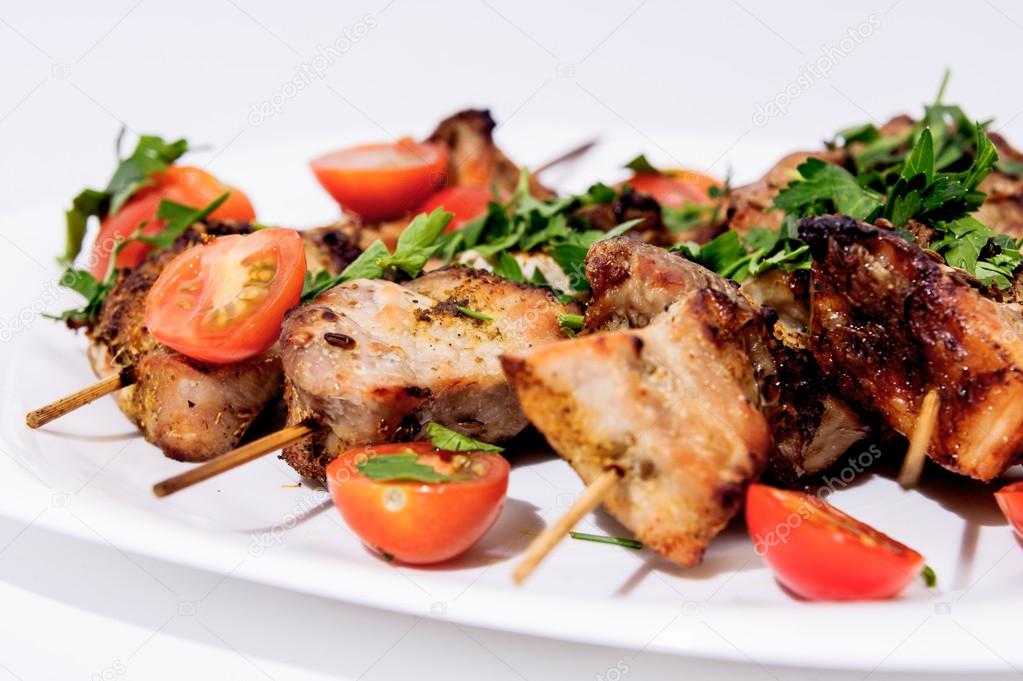 Barbecue on skewers, garnished with cherry
