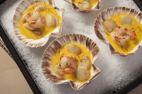 Shrimps and Scallops in Saffron sauce Stock Picture