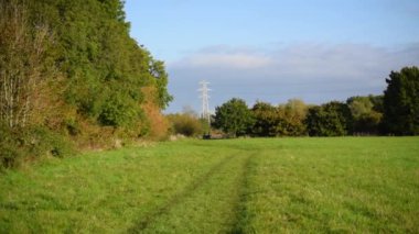 Power lines in English countryside slow motion.