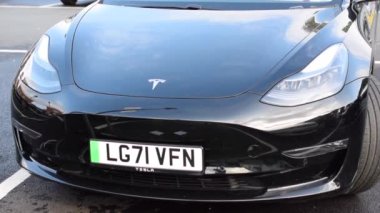  Close up shot of blue Tesla car on car park.