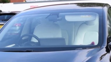  Close up shot of blue Tesla car on car park.