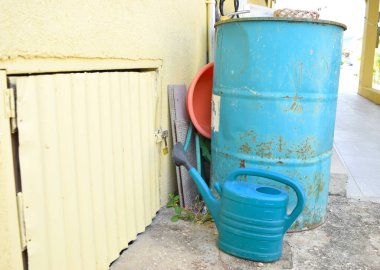 Water barrel and a watering can in the garden.