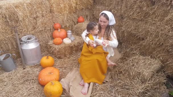 Young Mother Feeds Baby Girl Milk Bun Sitting Linen Cloth — Stockvideo