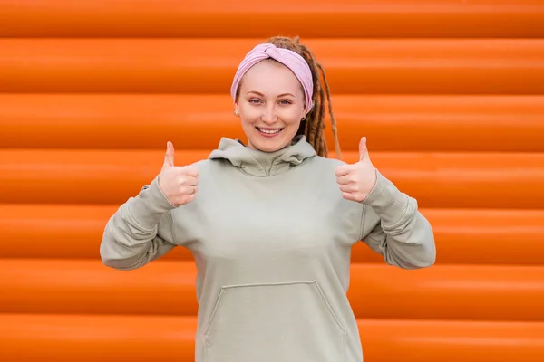 Portrait Smiling Woman Dreadlocks Giving Thumbs Orange Striped Background Copy — Stock Photo, Image