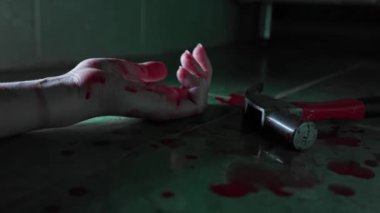 Kanlı kadının eli çekicin yanında yerde yatıyor ve ölüm krampları yaşıyor. Cinayet, suç ve şiddet kavramı.