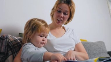 A speech therapist is engaged with a small child. Statement of speech pronunciation. Slow motion